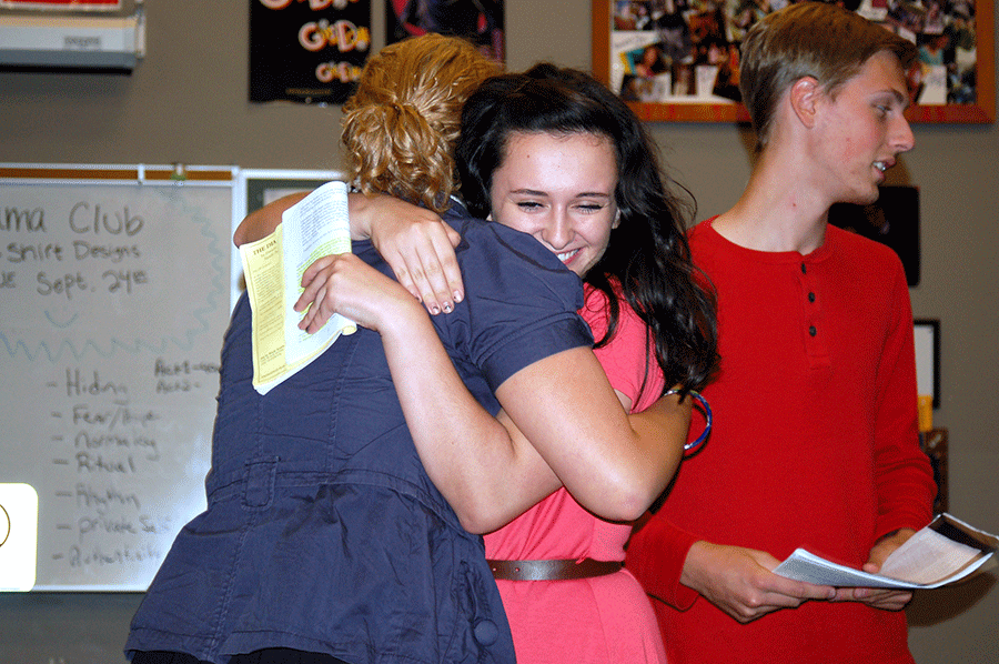 Anne Frank (Grace McWatters, 12) hugs Miep Gies (Felix Neeleman, 11) with Otto Frank (Coleman Holt, 12) in the background.