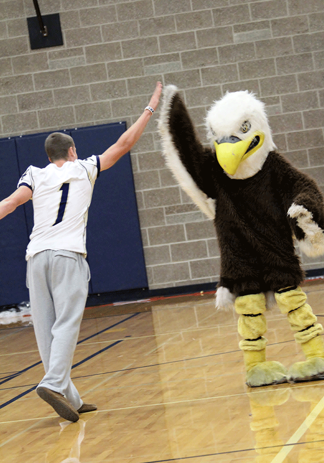 Eagle high fives senior Max Gray at the assembly Friday September 20.