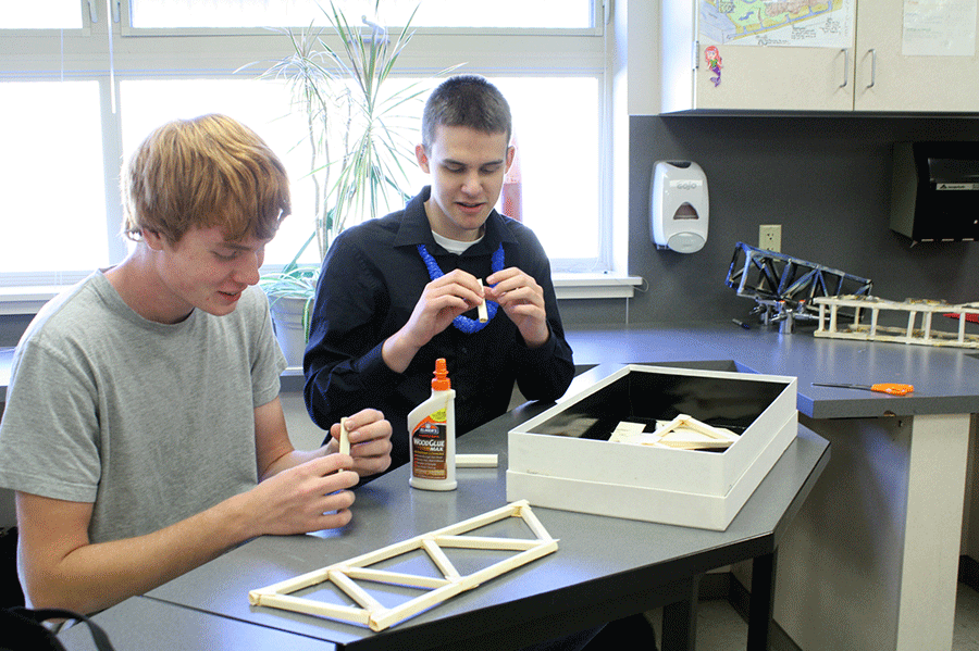 Jakob Erickson and Cody Schwans construct their Physics bridge using only three manila folders and glue on October 17.
