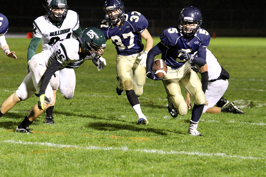 Senior Austin Wells carries the ball with sophomore George Spady running interference.