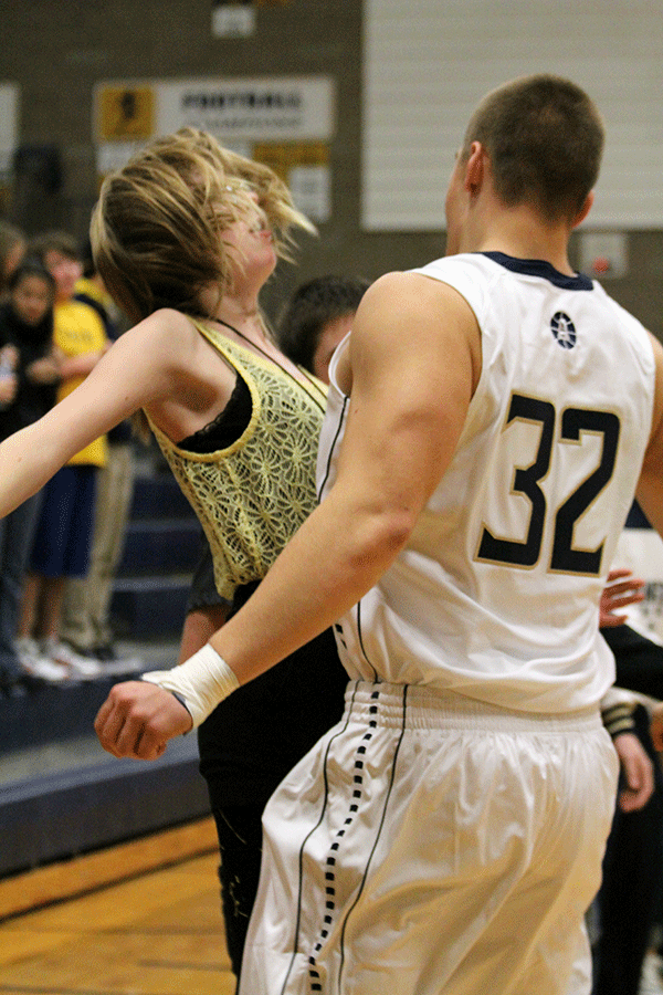 Seniors Brenna Kamppi and Nate Lewis chest bump at the basketball game Thursday.