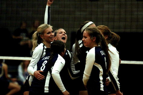 The volleyball girls celebrate a kill during one of their first home games. 