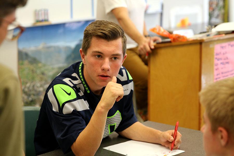 Sophomore Sean McCauley debates with his teammates about the correct answer at Knowledge Bowl practice on October 6th.