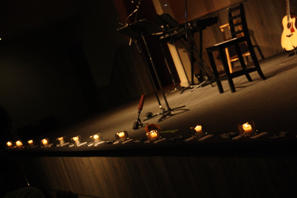 Candles light up the stage during the Grove Church’s vigil service in the wake of the shooting at Marysville Pilchuck High School.
