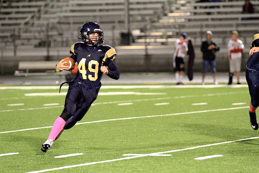 Freshman Chase Welton runs the ball against Stanwood during the 2nd quarter of the game on October 15. 