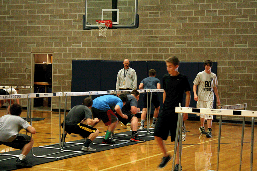 Mr. Hunter oversees his students’ progress during a workout in his Speed Power and Agility class. 