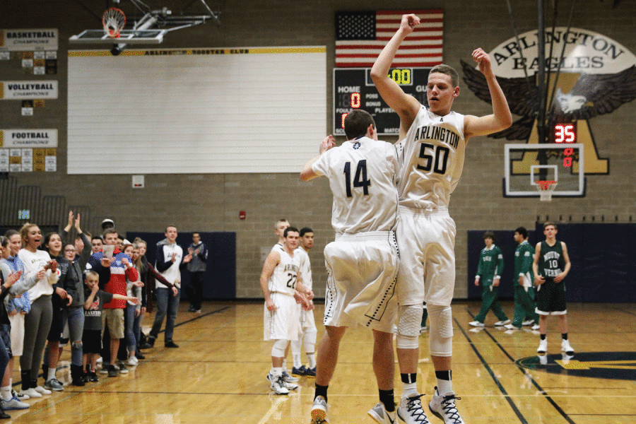 Jeremy Bishop (12) and Tim Zachman (11) greet each other before the varsity boys basketball game on the 2nd. 