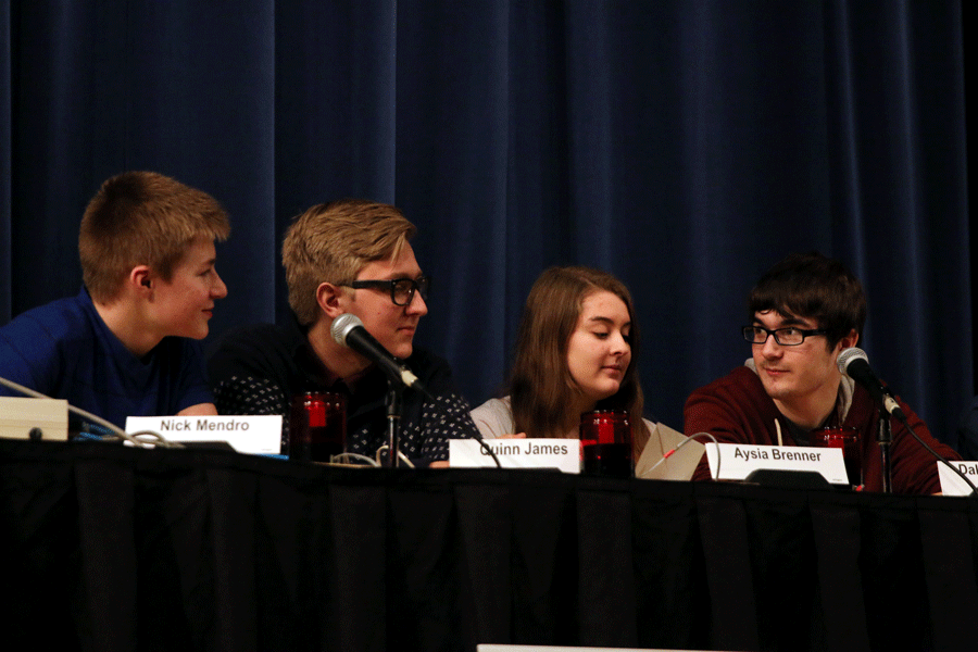 Nick Mendro, Quinn James, Aysia Brenner, and Dakota Brenner answer questions for a Hi-Q competition. The team won the competition  with an eight point lead.