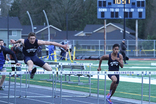 Cordell Cummings ’16 and Seth Quimzon ’17 jump over obstacles during the 110m Hurdle, placing in the top three with times 16.98 (Cummings) and 17.75 (Quimzon).