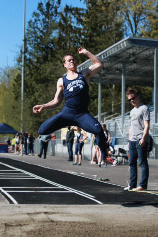 Kyler Smith (11) works on his long jump during a track and field practice 