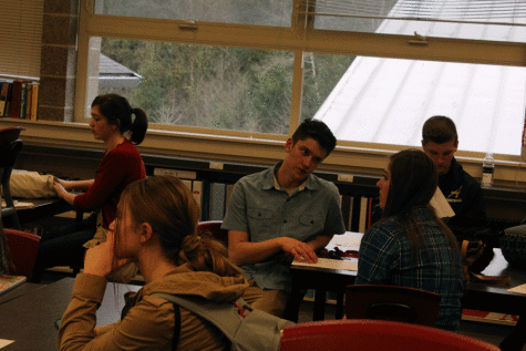 Juniors and seniors chat while waiting for a National Honor Society meeting to begin.