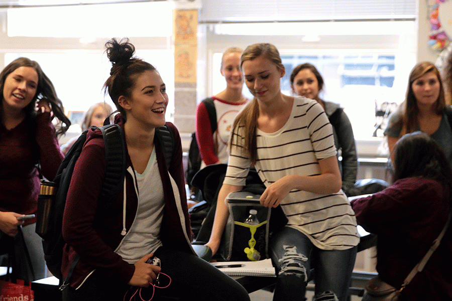NHS members Sevi Bielser (16) and Mckenna Herring (16)  laugh during the first NHS meeting of the year.