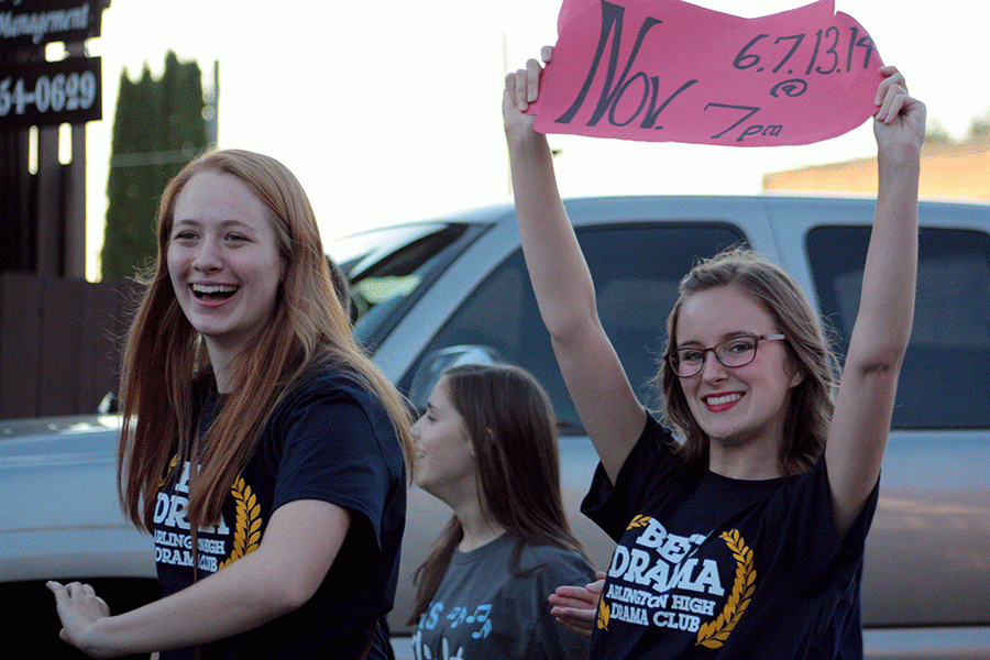Drama club members Emma VanderWeyst (16) and Emily Johnson (16) begin to march in the Homecoming Parade on September 30th. 