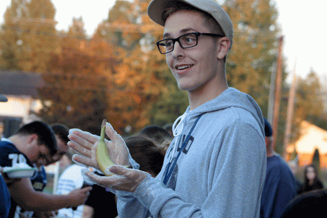 Senior Nick McDonald prepares a banana for the B.Y.O.B. section of the Homecoming Tailgate. 