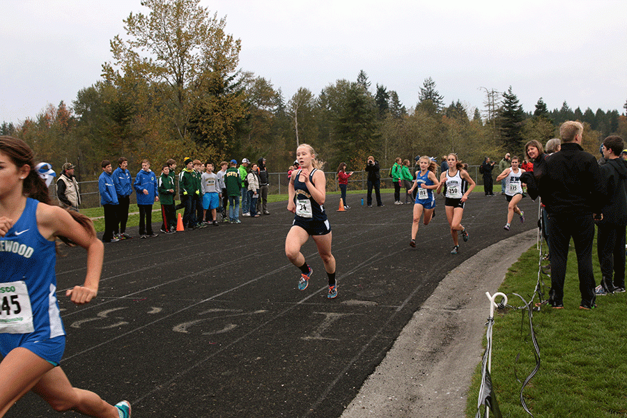 Emma Janousek (16) placed seventh overall at the League Championships on Saturday. The girls and boys teams both dominated the meet. 