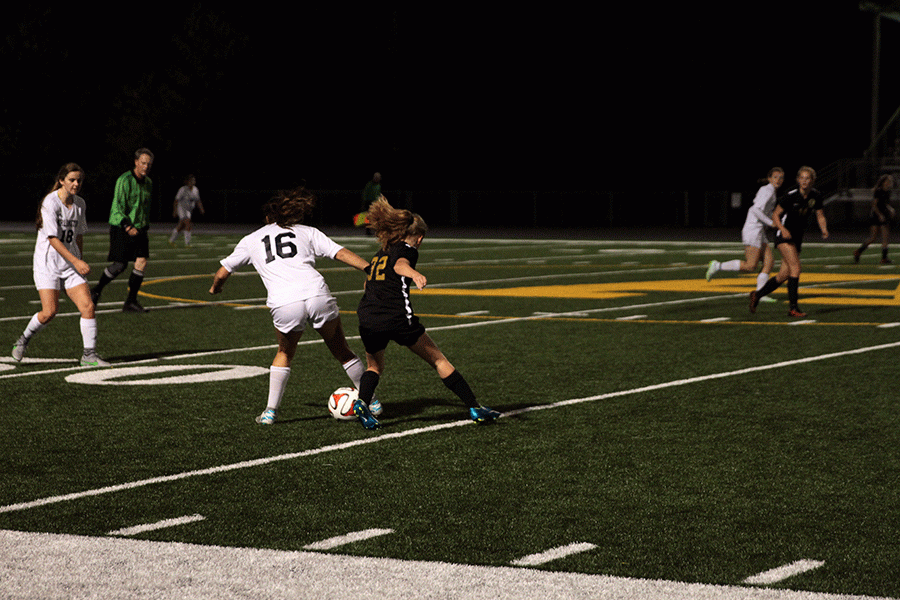 Danielle Baker (16) takes the ball from a Lynnwood opponent during Senior Night.