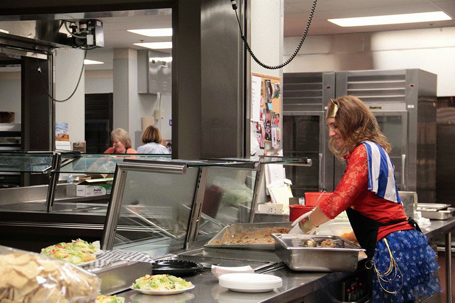 Wonder Woman, otherwise known as Lunch Lady Carol Mitzelfeldt, cleans up after lunch on Friday, October 30. 