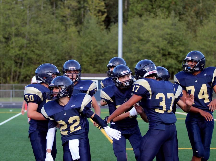 Members of the freshman football team celebrate after a touchdown. 