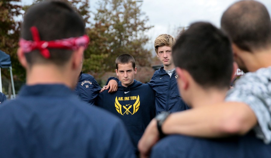 Zane Blanken (16) listens intently to Coach Murray while he prepares for the race at McCollum Park.