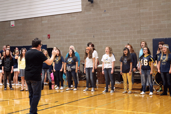 Members of the Aerie Choir singing in the gym. 