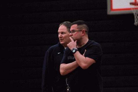 Arlington Coaches Nick Brown and Jeff Bryson watch as their team runs a drill during practice. 