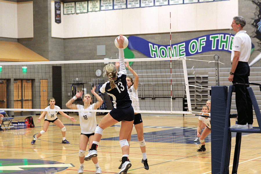 Junior Mackenzie Massey (#13)  goes up for a hit in the third of five games against Glacier Peak November 5.