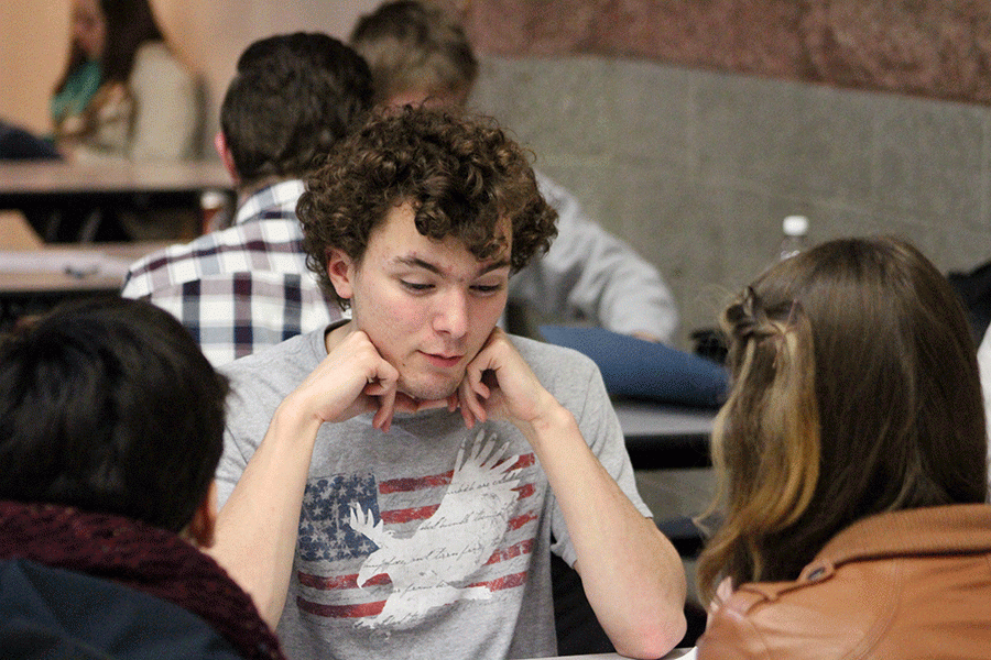 Ben Rosenthal (17), member of The Wikipedia Appreciation Society, discusses strategy with teammates Lily Janda (17) and Aysia Brenner (17) prior to the first oral round. 