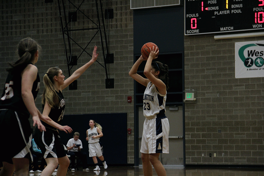 Hannah Carlson (18) looks to pass the ball during the JV Girls basketball game on December 2nd. 