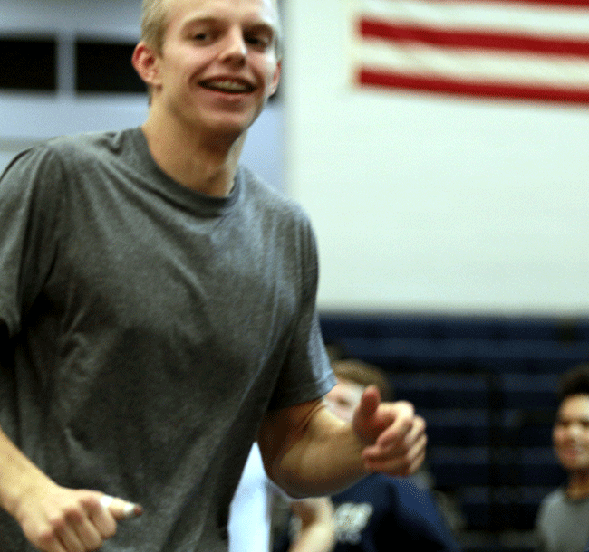 Jake Oesch (16) leads his team in warmups before a match.