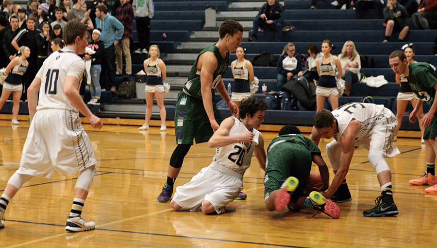 Jaren Carey (18) and Brennon Wiersma (16) try to maintain possession during a January 5th game against Edmonds-Woodway. 