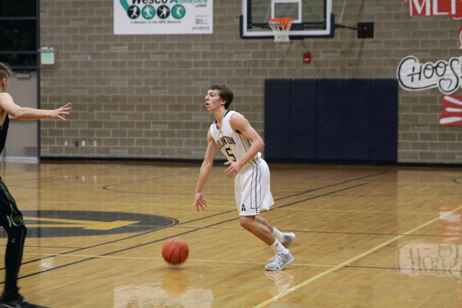 Aaron Carlson (16) dribbles up the court during a game against Marysville-Getchell. The Eagles would win the game, 60-52. 