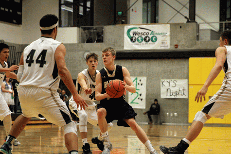 Drew Bryson (17) drives into the lane amidst a swarm of Getchell defenders. The junior guard finished with 20 points in the win. 