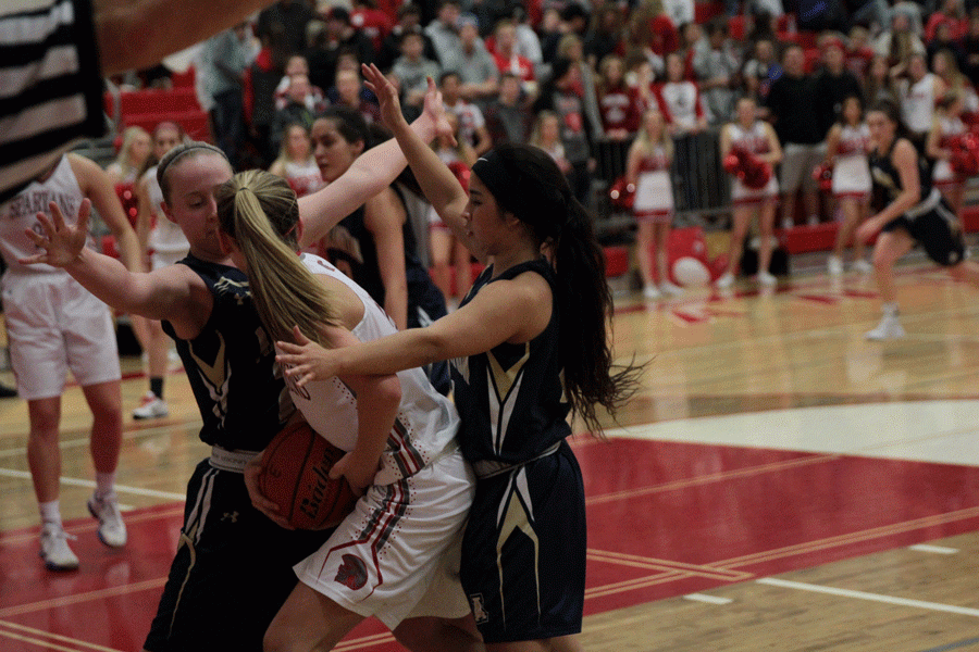 Emma Janousek (16) and Serafina Balderas (16) double team a Stanwood opponent en route to a 62-41 victory against the Spartans.
