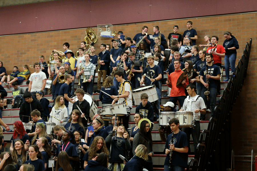 The Arlington band cheers on the girls' basketball team at Saturday night's playoff game. 