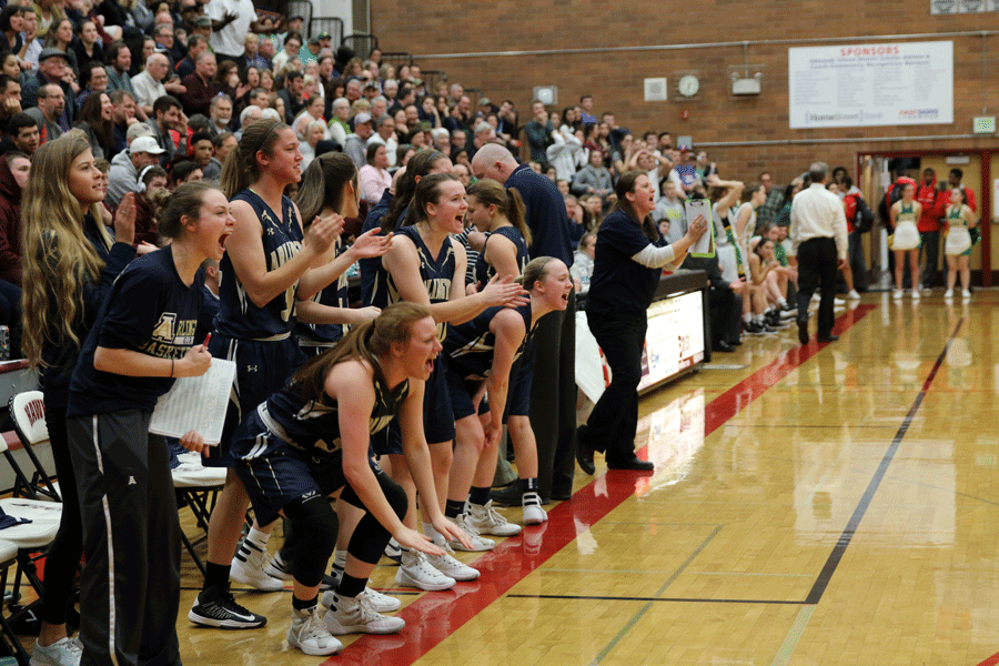 The Arlington girls' sideline explodes with excitement after a foul is called on Bishop-Blanchet. The Eagle would go on to win the game, 49-30.