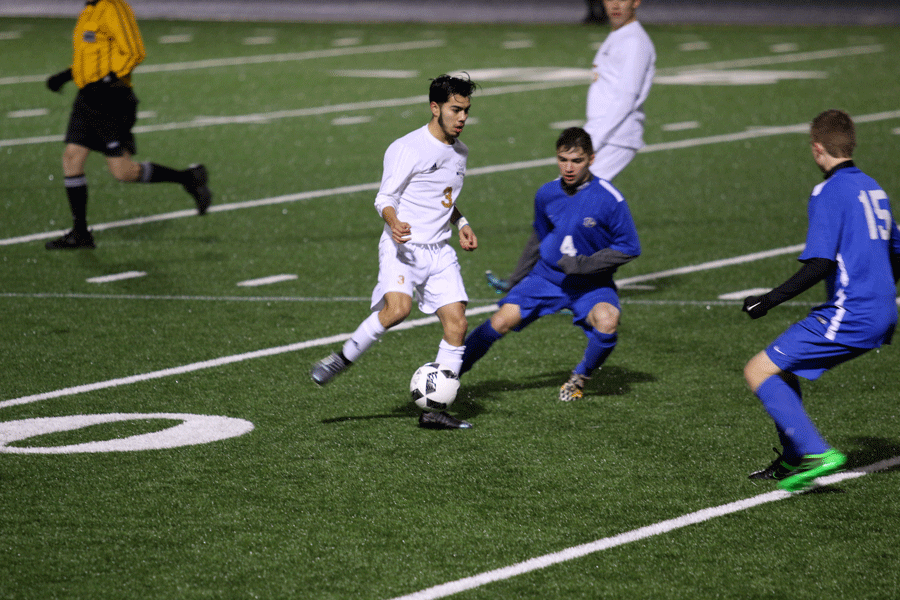 Aaron Paloalto ('16) dribbles around a Ferndale defender during a game on March 12th. 