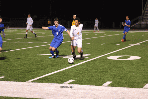 Stephen Caponey (17) battles a Ferndale defender in a tie against the Golden Eagles.