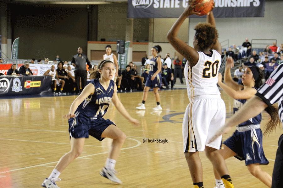 Peyton Brown ('18) and Serafina Balderas ('16) defend against a Lincoln player in Thursday night's playoff game. 