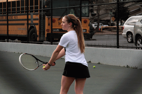 Livia Valentina Markwart (17) prepares to serve to her opponent during a match against Mariner. 