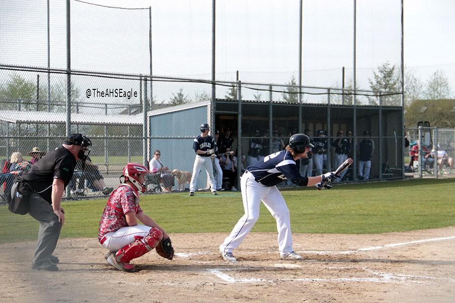 Drew Carlson (16) tries to put down a bunt during a game against Stanwood on April 8th. Carlson would later single in the at-bat.