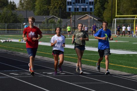 Dawson Andrews ('18), Vivian Potong ('20), Kelsey Lee ('19) and Brian Barene ('20) run together during the Arlington Cross Country's twelve hour relay event August 29. The team went on to raise upwards of 4,000 dollars.