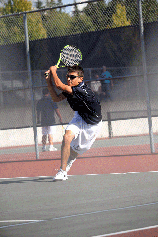 Conner Fochasato (18) assists the Boys Varsity Tennis Team by winning his match against Standwood. In the end, the Eagles win. 