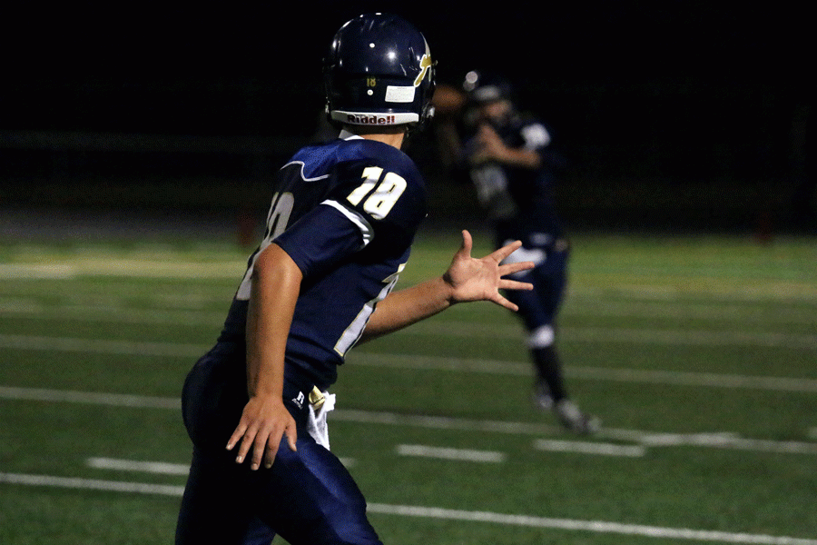 #18 Christian Waldal (18) anticipates a pass from Quarterback #11 Campbell Hudson (18) as he sprints down field in Fridays game. 