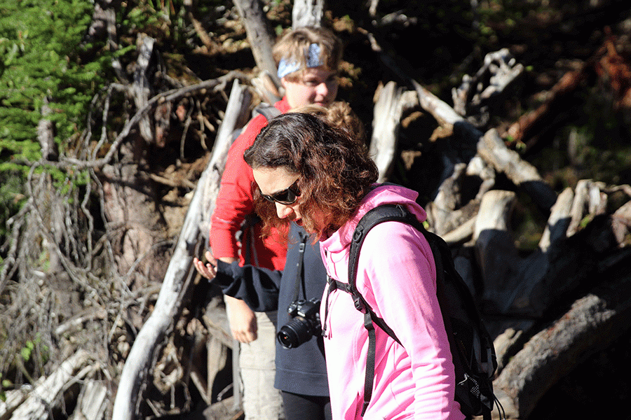 Ecology club advisor Haifa Iversen waits for ecology club members Julie Wignall (18) and Casey Sharpe (17) to cross a bridge during their club hike September 12, 2016 at Monte Cristo Ghost Town. 