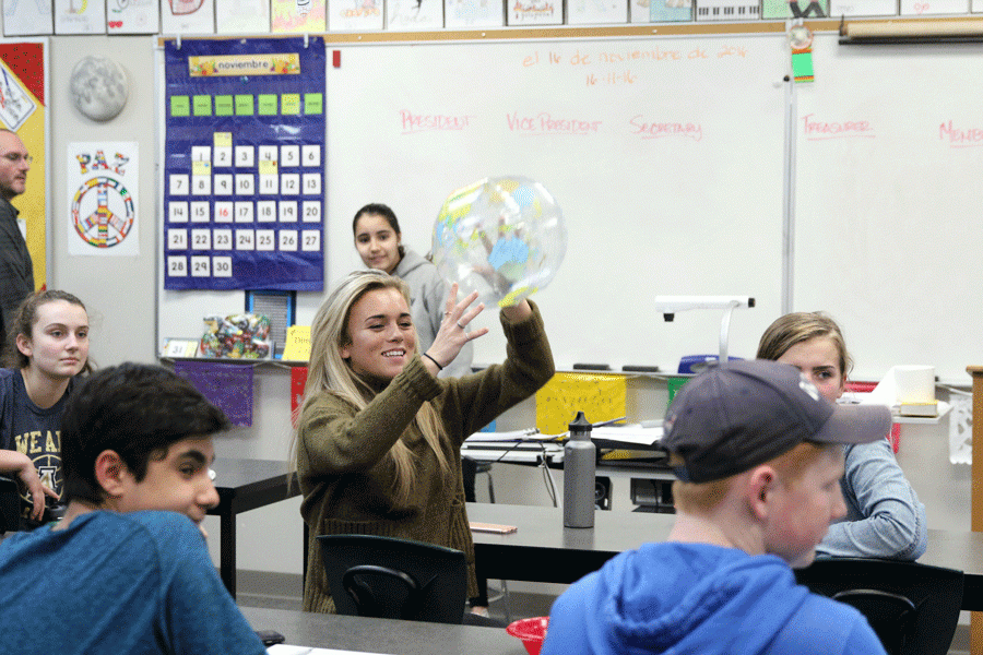 Michaela Camlin (18) throws the globe during a bonding activity on the first Interact Club Meeting.