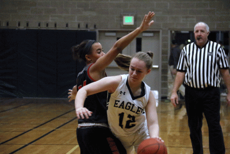 Sophomore Mollie Janousek #12 drives into the basket against Mountlake Terrace Hawks on Friday, January 6th. 