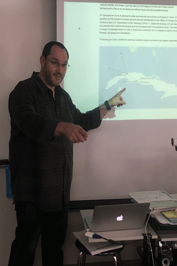 Explaining details of the trip, Mr. Duskin goes over the map of Cuba.