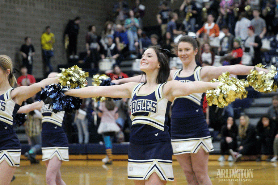 Shailyn Berry (17) and Hannah Flick (17) pumps up the crowd during half time of the Varsity Basketball game.