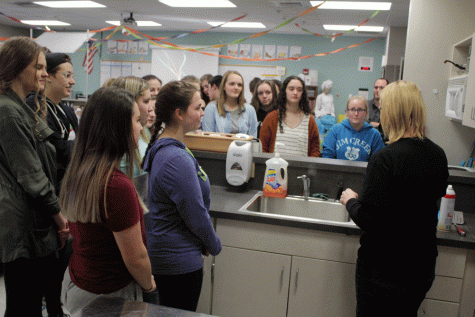Madame Taylor skillfully demonstrates how to make the first crepe to a crowd of eager and hungry club members. 