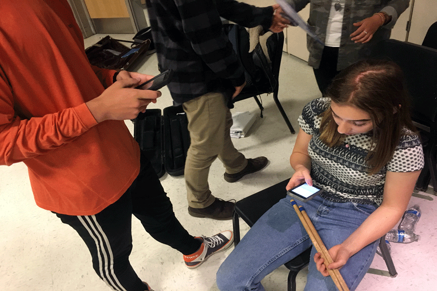 Jack+Hamilton+and+Cami+Hannah+are+engrossed+by+their+phones+during+class.